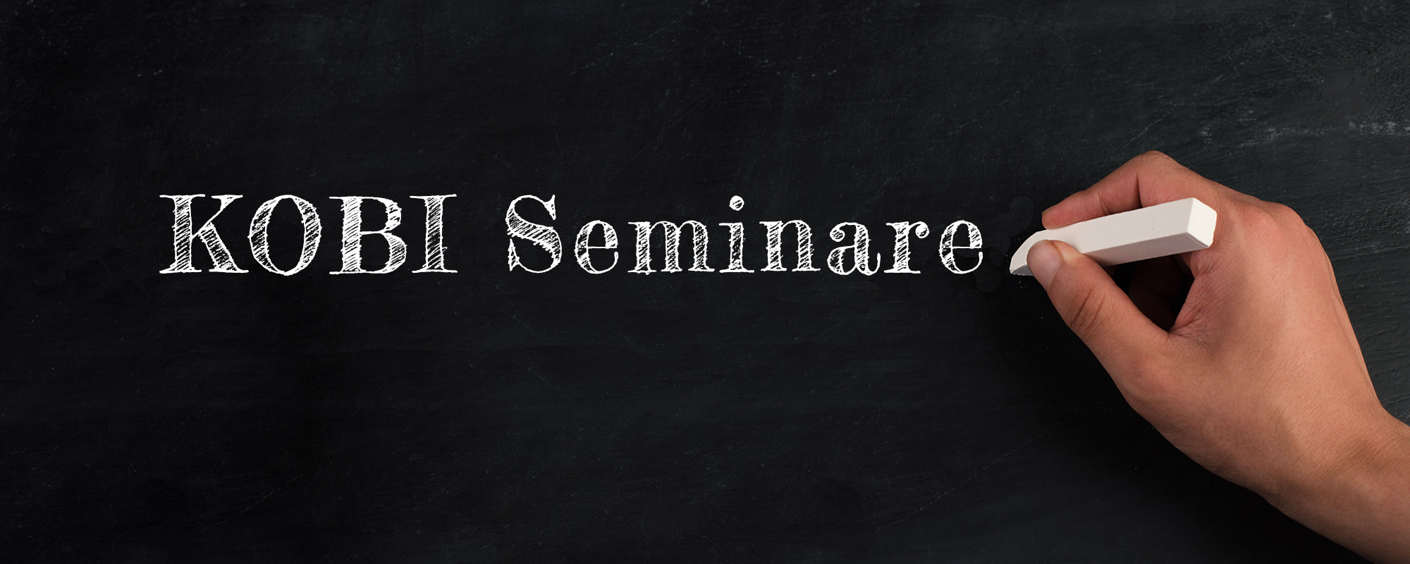The word workshop is standing on wooden cubes, sign up now bottom, chalkboard background